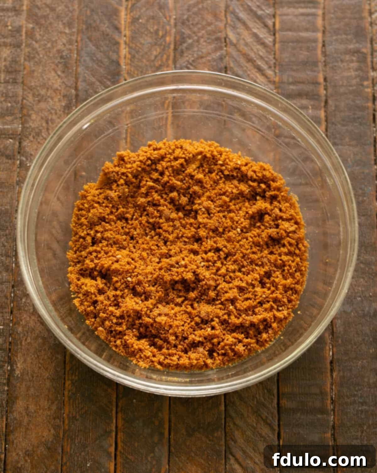 Mixing cookie crumbs and butter together until well combined.