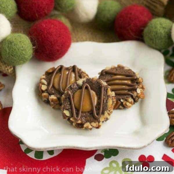 Turtle Thumbprint Cookies on a square white plate, showcasing their rich chocolate, caramel, and pecan topping.