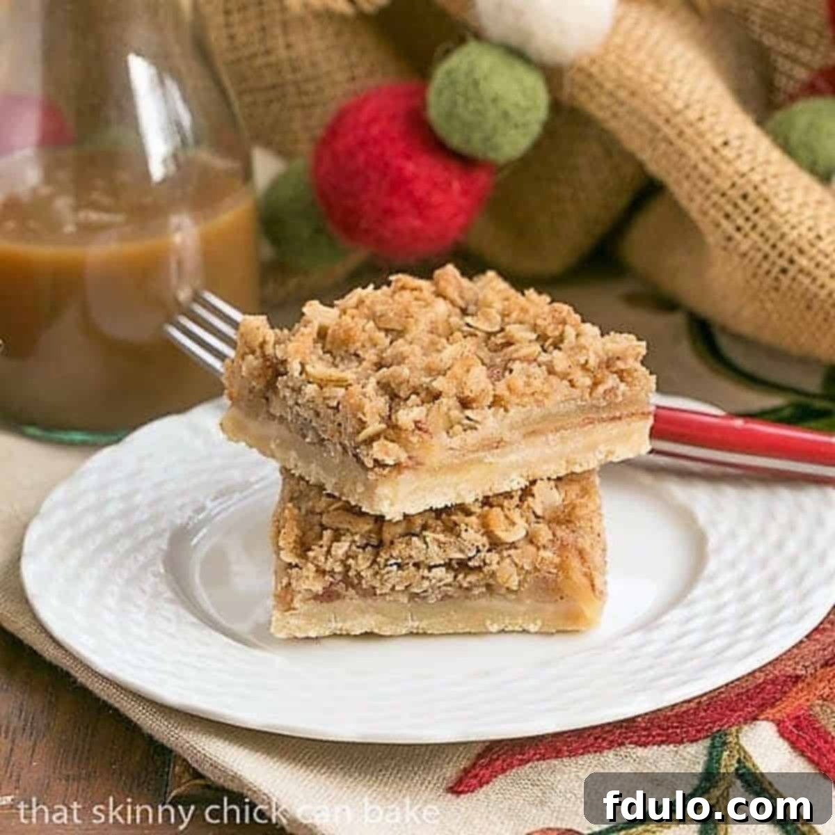 Delicious Apple Streusel Bars stacked neatly on a white dessert plate, ready to be enjoyed.