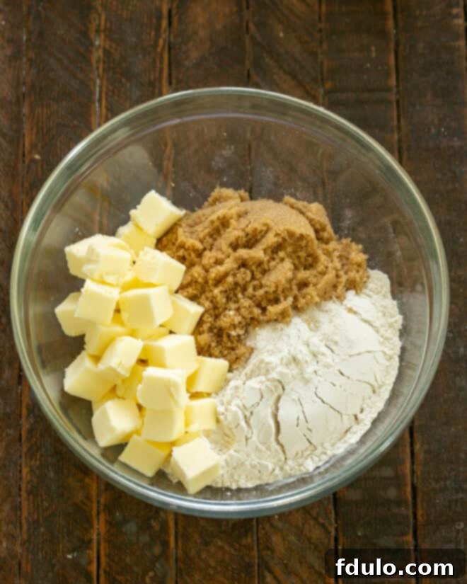 Apple crisp topping ingredients, including flour, brown sugar, and butter, ready for mixing.