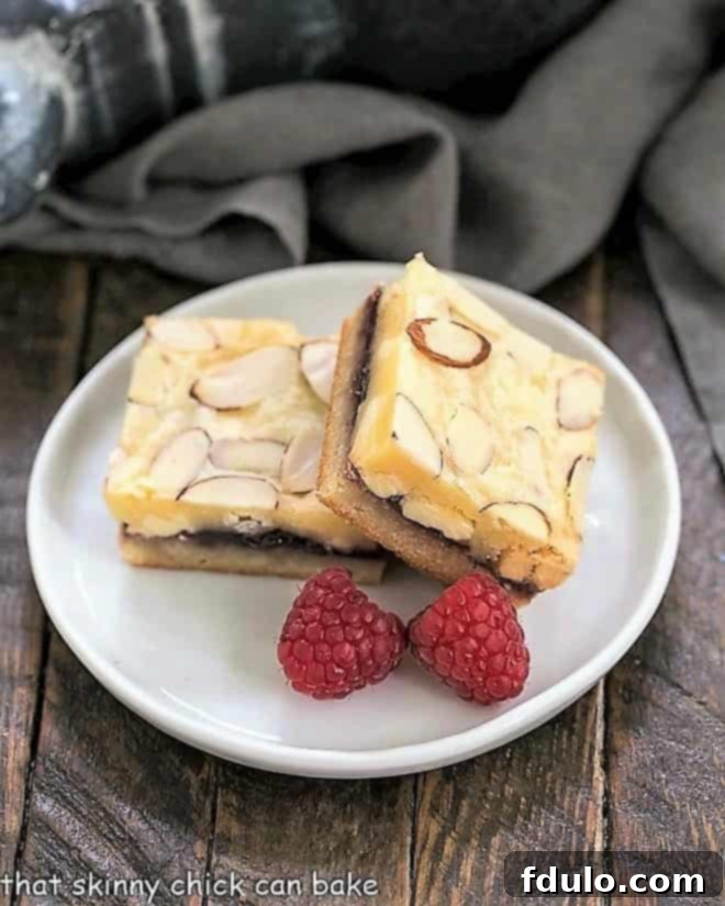 Raspberry Filled White Chocolate Bar on a round white plate with 2 raspberries