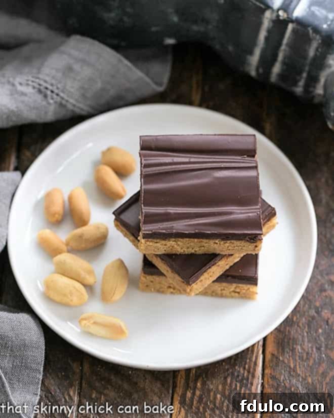 Homemade Reese's Bars - All the magnificent flavors of a Reese's peanut butter cup in a no-bake bar Homemade Reese's Bars on a round white plate viewed from above.