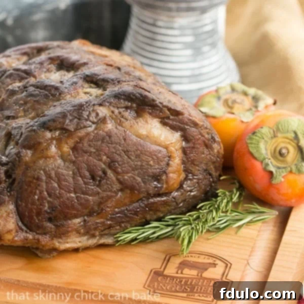 A whole Classic Prime Rib roast resting on a wooden cutting board, ready for carving.