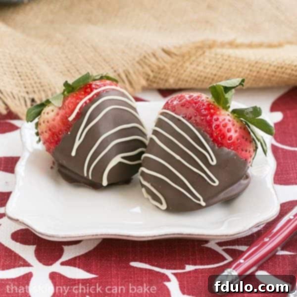 Mascarpone Filled Chocolate Covered Strawberries - A dreamy filling and chocolate coating make these strawberries unforgettable Mascarpone Filled Chocolate Covered Strawberries on a small white dessert plate