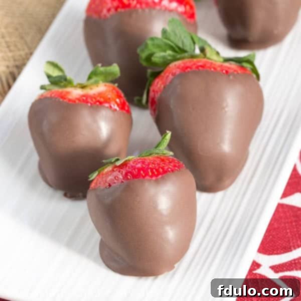 Mascarpone Filled Chocolate Covered Strawberries - a dreamy combination of berries, cream and chocolate! Mascarpone Filled Chocolate Dipped Strawberries on a serving tray