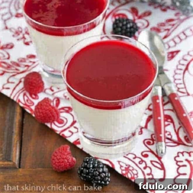 Vanilla Bean Panna Cotta in elegant glasses on a red and white patterned napkin with fresh berries, highlighting its exquisite presentation.