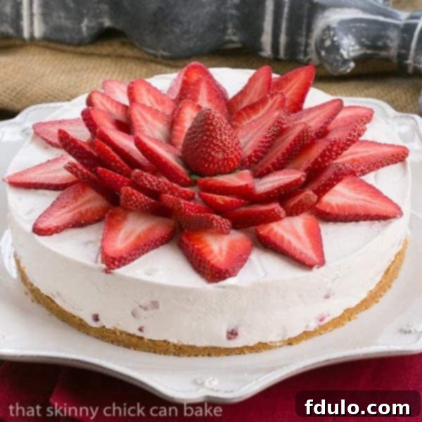 Strawberry Vanilla Cream Pie: A beautifully adorned pie with fresh strawberries, vanilla cream, and a graham cracker crust, perfect for any celebration.