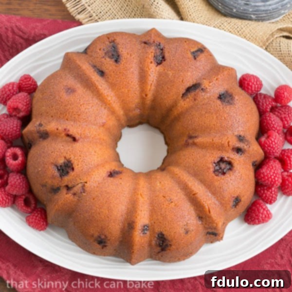 Overhead view of Raspberry Amaretto Bundt Cake on a white, oval platter.