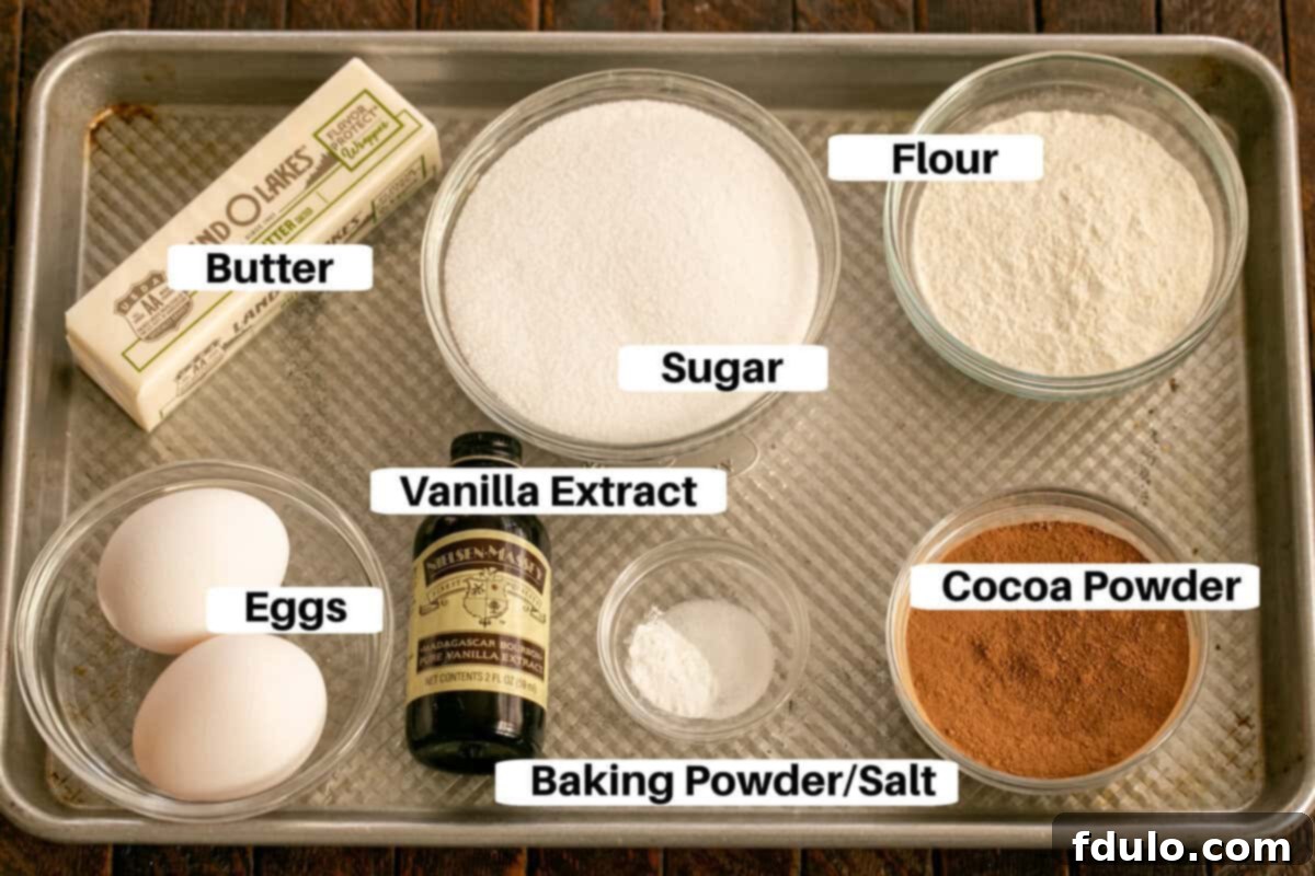 All ingredients for homemade frosted brownies laid out on a sheet pan with labels.