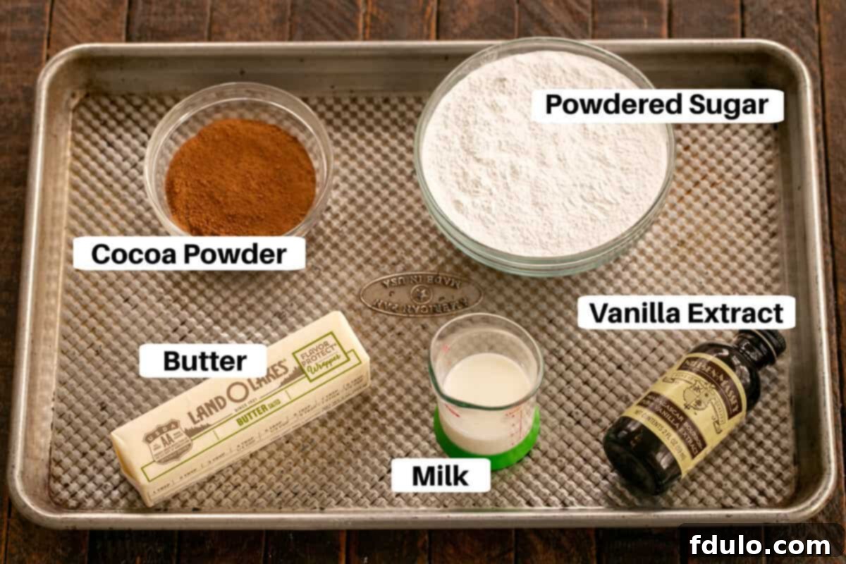 Ingredients for chocolate buttercream frosting arranged on a sheet pan for the frosted brownies recipe.