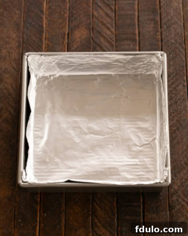 Baking pan lined with non-stick foil, ready for brownie batter.