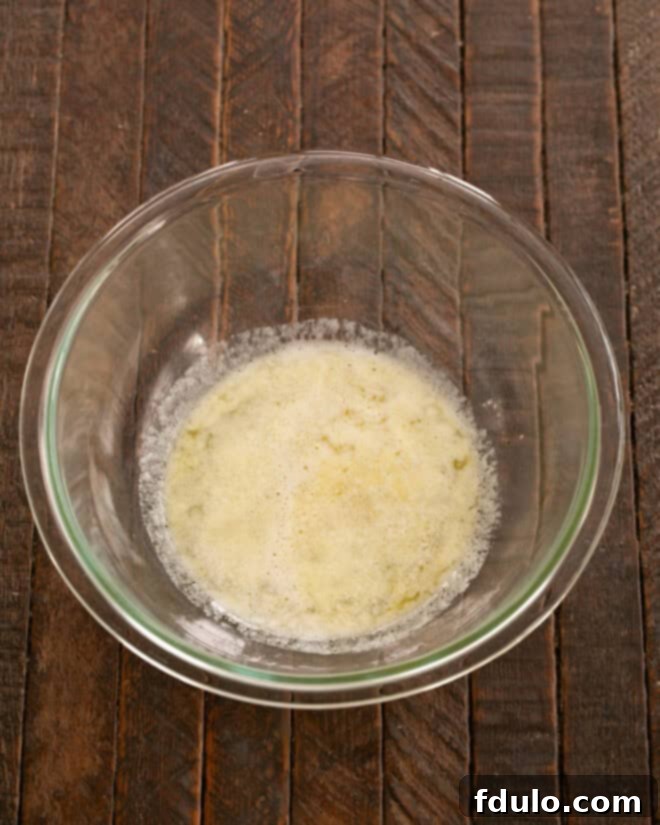 Melted butter in a microwave-safe bowl.