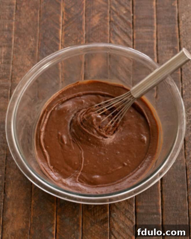 Mixing brownie batter ingredients in a bowl.