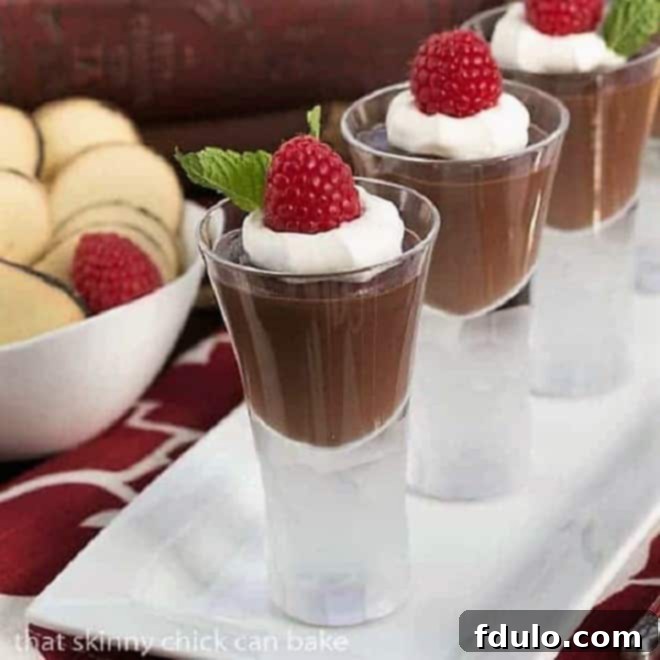 Rich Double Chocolate Pudding in elegant shot glasses on a pristine white tray, showcasing its smooth, dark texture.
