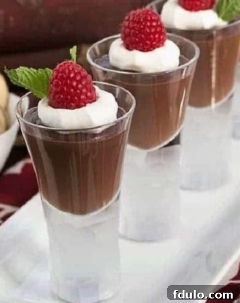 Garnished double chocolate pudding in a glass on a white tray, ready to be enjoyed.