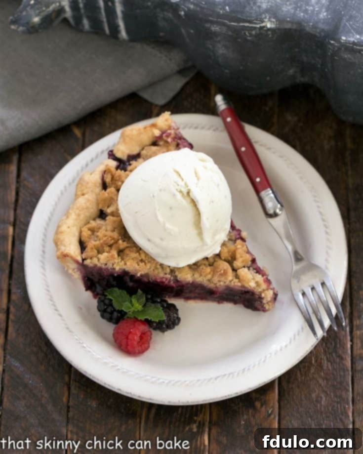 Overhead slice of razzleberry pie ala mode with a scoop of vanilla ice cream