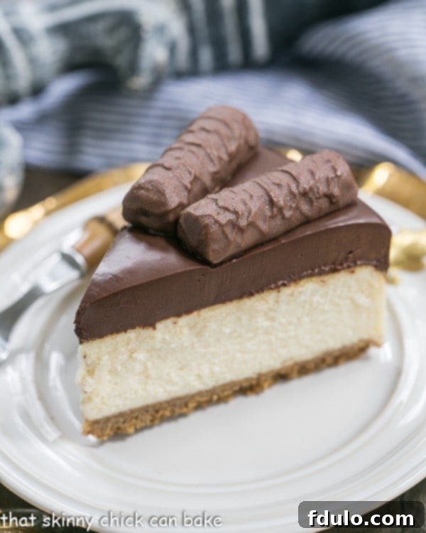 A delightful slice of Twix Cheesecake on a white plate, expertly cut and garnished.