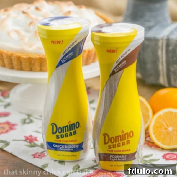 A close-up view of the golden, swirled meringue topping on a Meyer Lemon Tart, showcasing its soft peaks and inviting texture.