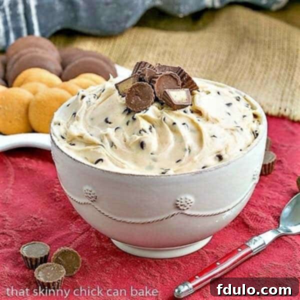 Peanut Butter Tagalong Dip in a ceramic bowl with a red handled spoon