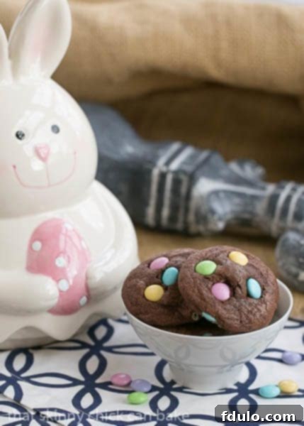 Chocolate Cookies for Easter - Chewy Brownie Cookies speckled with leftover Easter candy Overhead view of Chocolate Cookies with Easter M&Ms, highlighting the vibrant pastel candies embedded in the dark chocolate cookies.