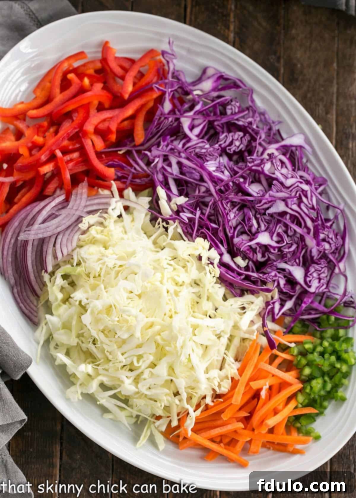 Salad ingredients for Asian Salad Recipe, including shredded cabbage, carrots, bell peppers, and snow peas.