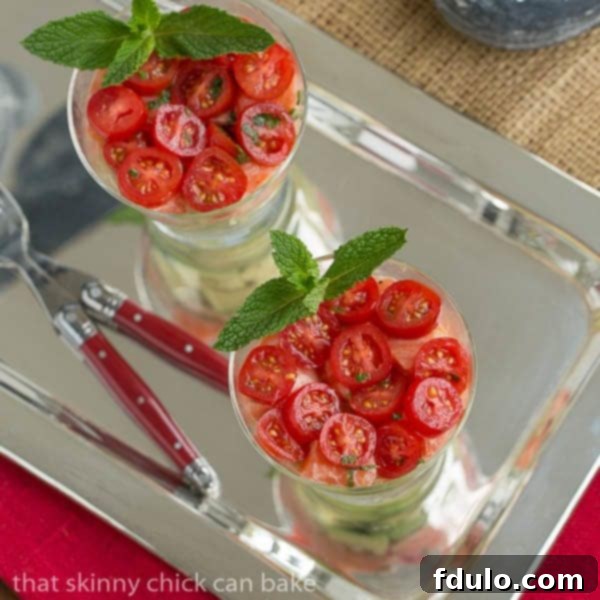 Overhead view of easy salmon tartare glasses garnished with mint, displaying the meticulously layered ingredients.