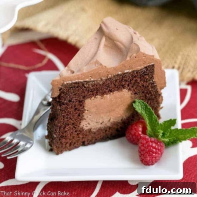 Tunnel of Mousse Cake- A fine crumb chocolate cake filled and frosting with a dreamy chocolate mousse! Tunnel of Mousse Cake slice on a square white dessert plate.