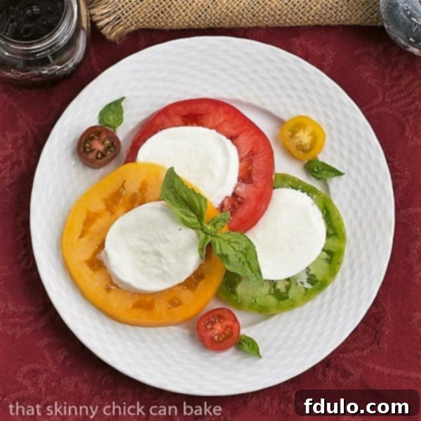 Overhead view Salade de Tomates et Fromage on a white basketweave plate