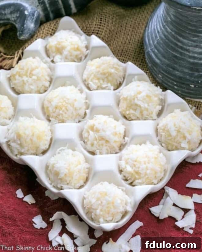 A charming close-up of Coconut White Chocolate Truffles nestled gently within a ceramic egg crate, highlighting their rustic elegance.