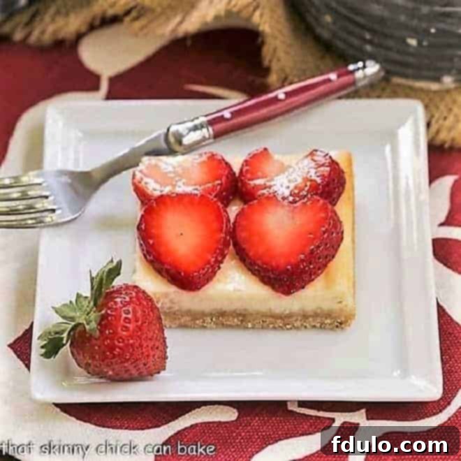A single Strawberry Cheesecake Bar on a square plate with a red handled fork, inviting a bite.