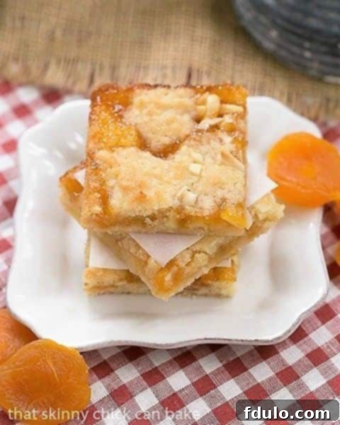 Coconut Apricot Bars garnished with dried apricots on a small square plate, ready to be served.