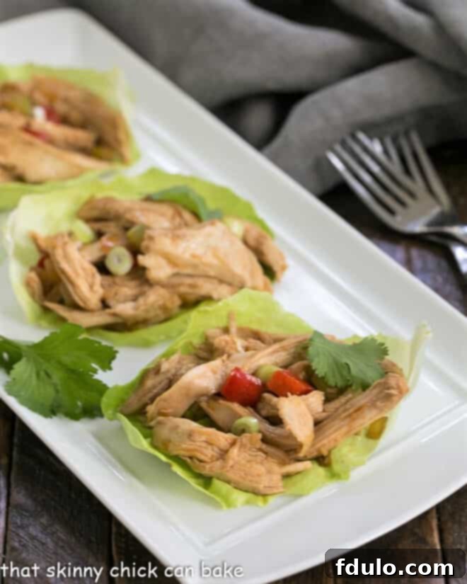 Delicious Shredded Chicken Lettuce Wraps elegantly arranged on a clean white serving tray, ready to be enjoyed as a healthy and flavorful meal.