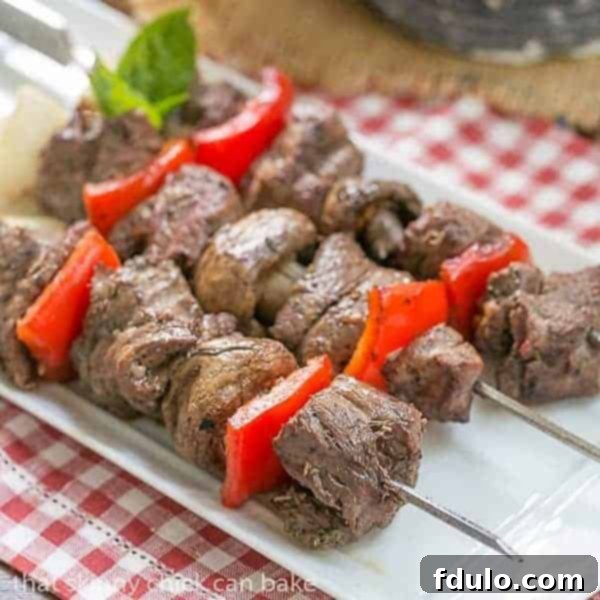 Tender Skewered Grilled Beef Steak Kabobs on a white tray
