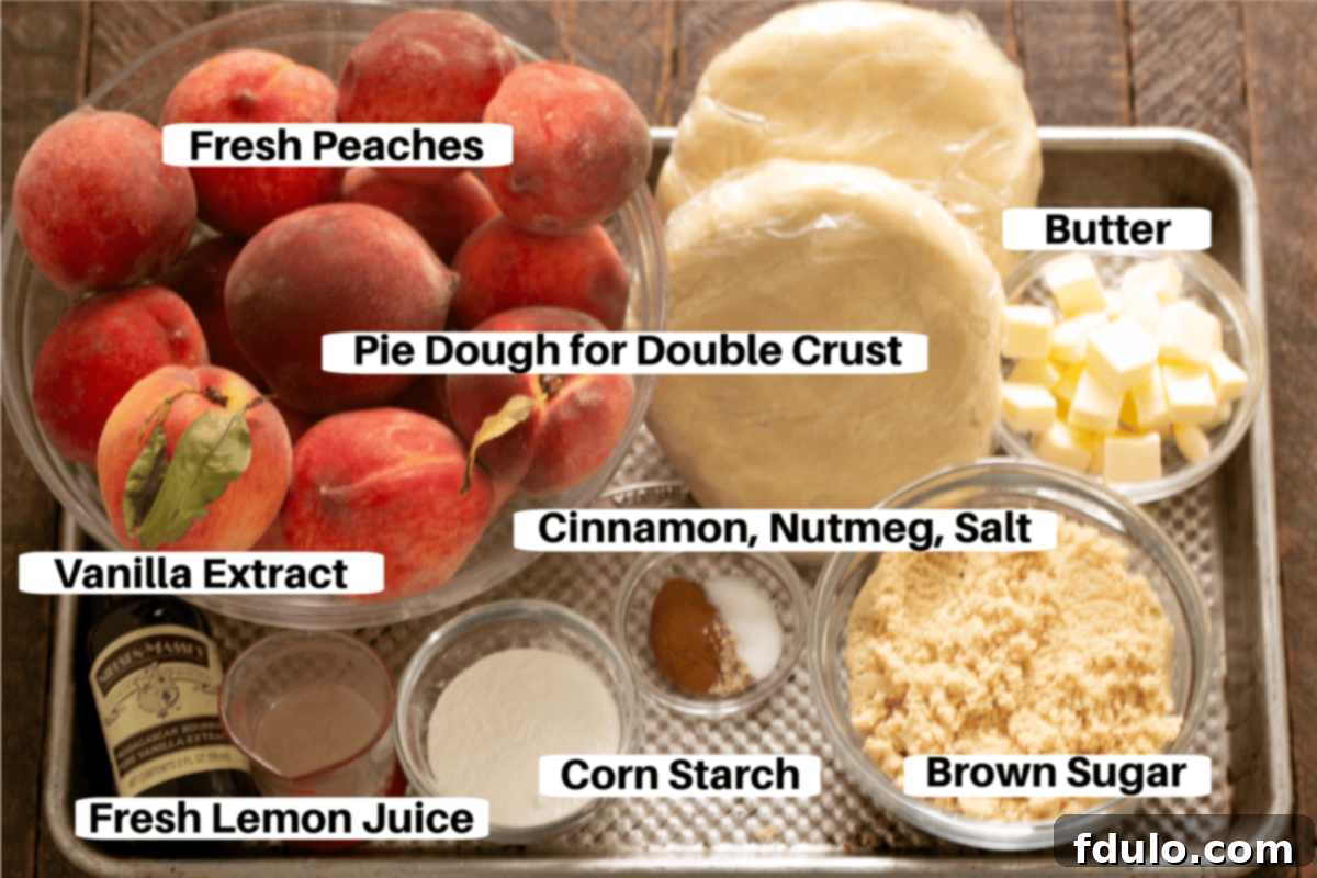 Fresh Peach Pie Ingredients laid out on a sheet pan with labels, including peaches, brown sugar, cornstarch, lemon juice, butter, and spices.