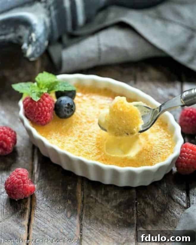 White Chocolate Crème Brûlée in a white ramekin with a spoon.