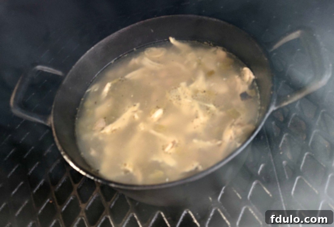 Smoky Dutch Oven Turkey Chili 4 Dutch Oven Smoked Turkey Chili simmering uncovered on a pellet smoker, absorbing rich smoky flavor.