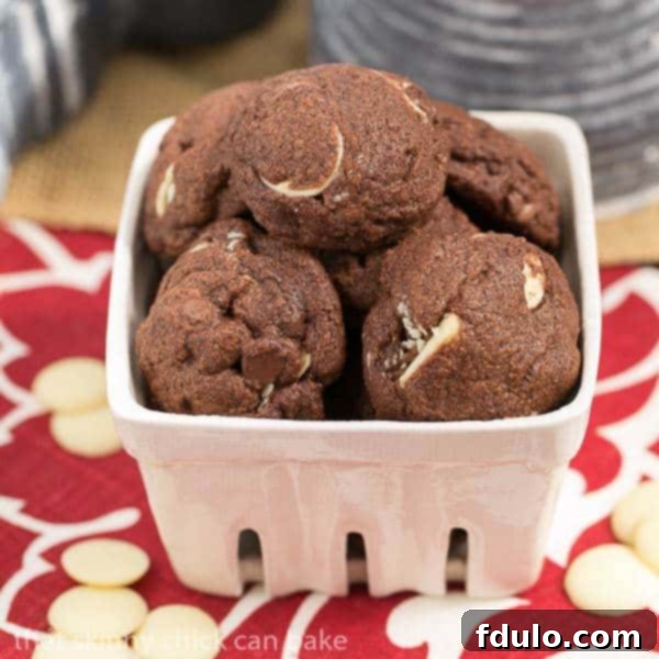 Triple chocolate chip cookies in a white ceramic basket.