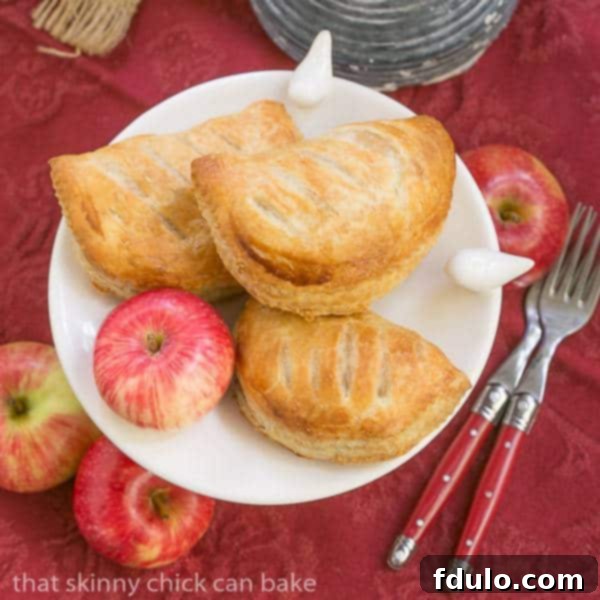 Chaussons aux Pommes overhead view on a white serving dish on a red napkin.