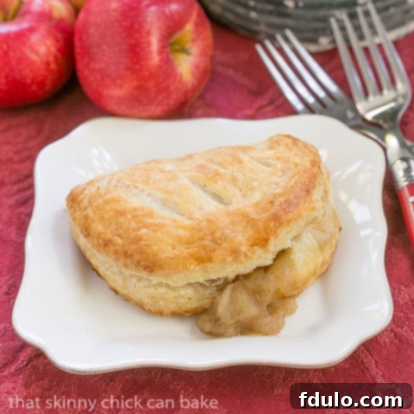 Chaussons aux Pommes with filling seeping out.