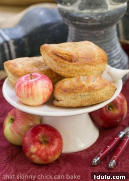 Chaussons aux Pommes on a ceramic tray with apples.