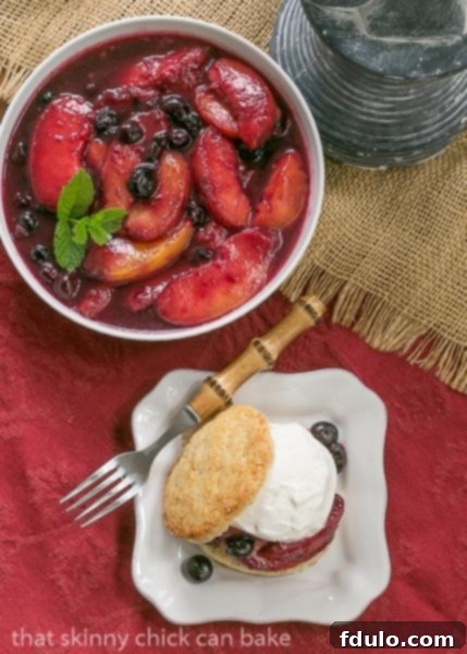 Overhead view of Blueberry Peach Shortcakes with a bowl of macerated peaches and blueberries