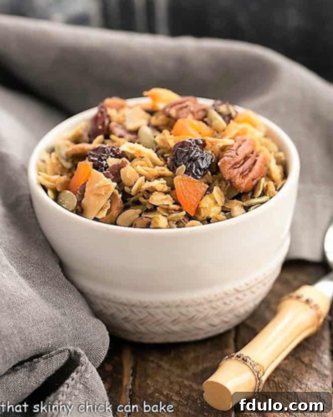 Tropical Maple Crunch Granola 3 Maple Coconut Granola in a white cereal bowl with a spoon