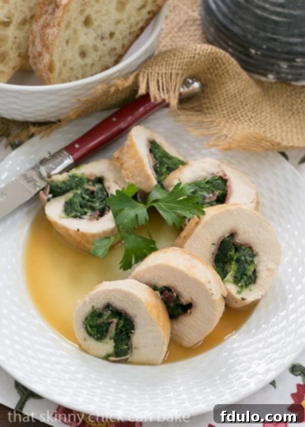 Artfully arranged Chicken Spinach and Prosciutto Pinwheels on a crisp white plate, showcasing their perfectly rolled layers and golden crust