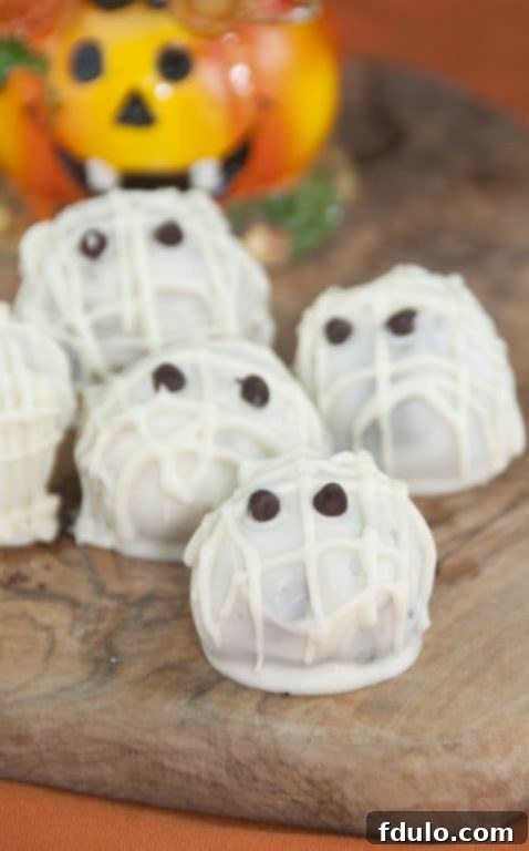 Halloween Mummy Oreo Truffles, made with crushed Oreos and cream cheese, decorated to resemble mummies.