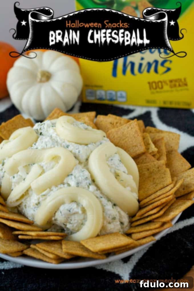 A gruesome yet delicious Halloween Brain Cheeseball, shaped and colored like a brain, ideal for a pre-trick-or-treating snack.