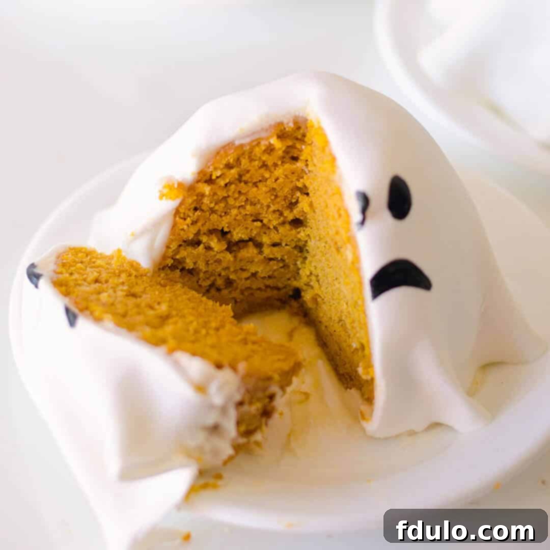 Mini Ghost Pumpkin Cakes, small and adorable pumpkin-shaped cakes decorated as friendly ghosts.