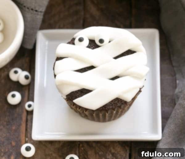 Simple Chocolate Cupcakes dressed up like adorable mummies, perfect for a Halloween party.