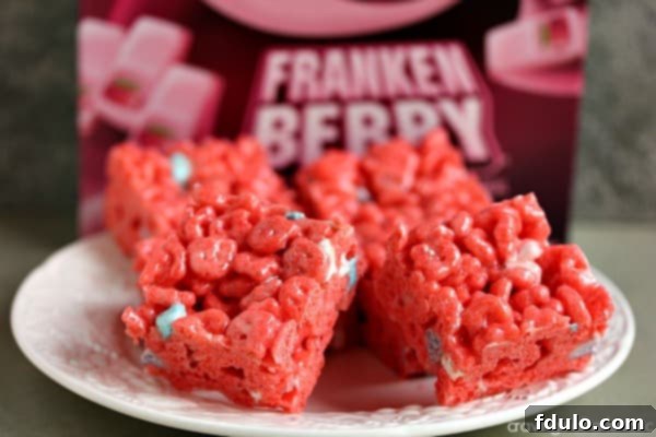 Pink Franken Berry Krispies treats, a colorful and playful take on the classic Rice Krispie treats, ideal for Halloween.
