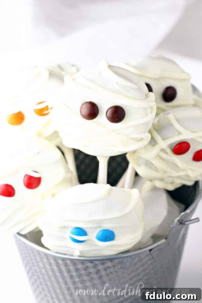 Mummy Pops made from Double Stuff Oreos dipped in white chocolate and decorated to look like mummies.