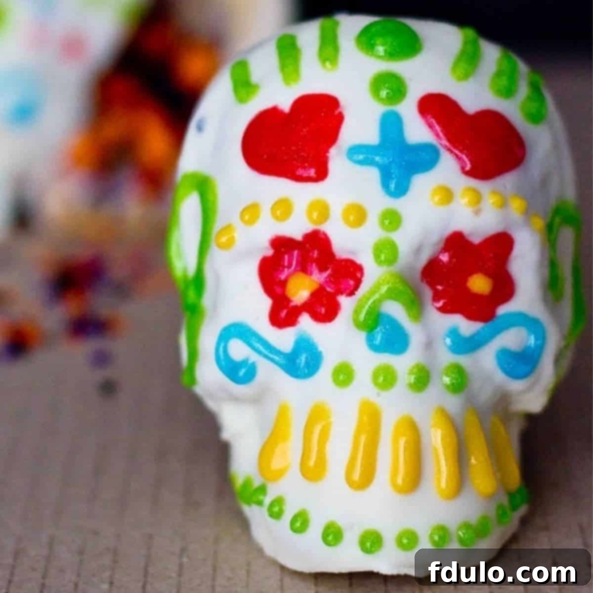 Beautiful mini confetti cakes adorned with festive Dia de los Muertos decorations, celebrating the Day of the Dead.